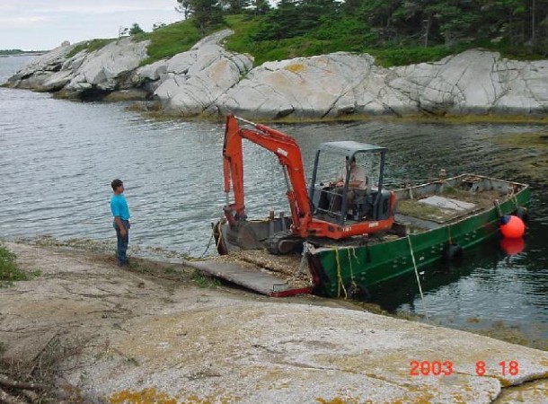<span>Unloading:</span> Mini excatator arrives at the island